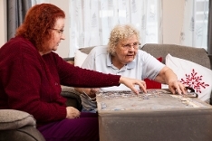 Older ladies doing puzzle Older ladies doing puzzle